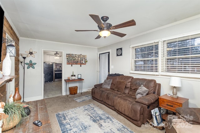 living room with crown molding, ceiling fan, a healthy amount of sunlight, and carpet