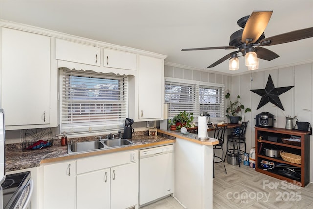 kitchen featuring sink, stainless steel electric range, white dishwasher, ornamental molding, and white cabinets