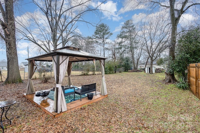 view of yard with a gazebo and a storage shed