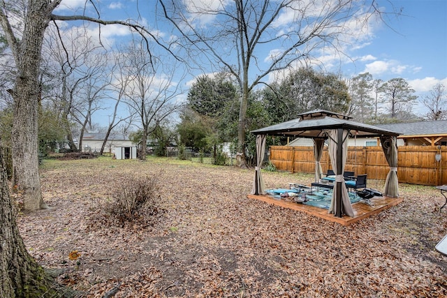 view of yard featuring a gazebo and a storage unit