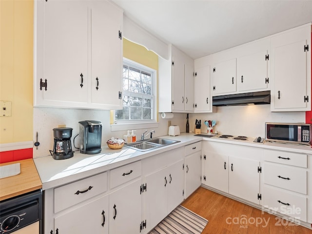 kitchen featuring white cabinetry, appliances with stainless steel finishes, sink, and light hardwood / wood-style flooring