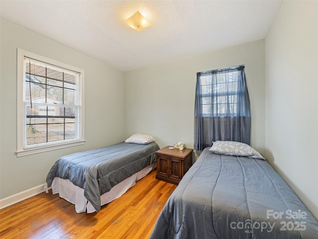 bedroom with hardwood / wood-style flooring and a textured ceiling