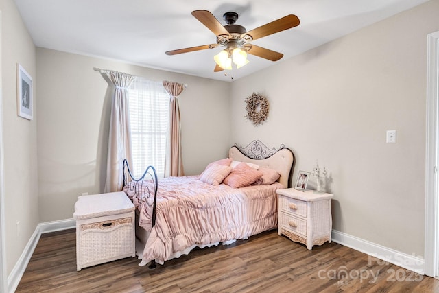 bedroom with dark hardwood / wood-style floors and ceiling fan