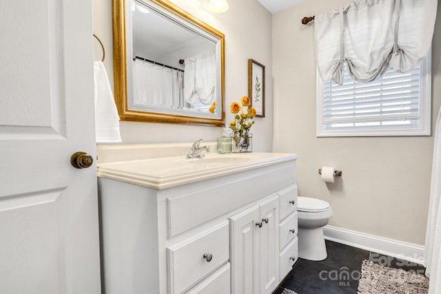 bathroom featuring vanity, tile patterned floors, and toilet