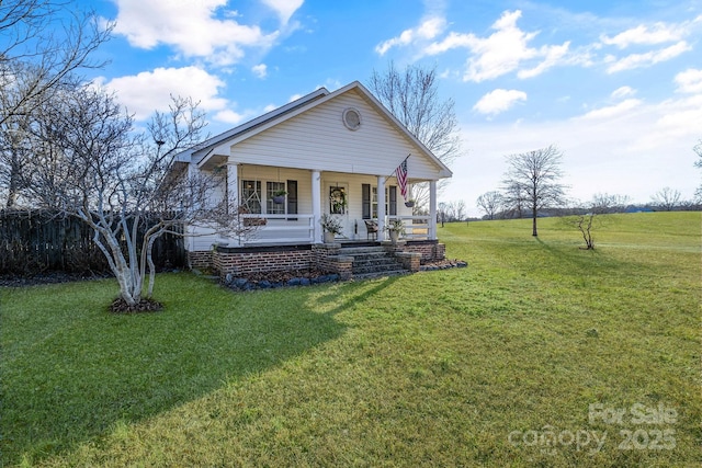 view of front facade with covered porch and a front yard