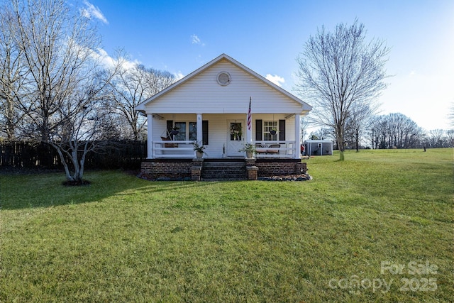 view of front of house with a front yard and covered porch