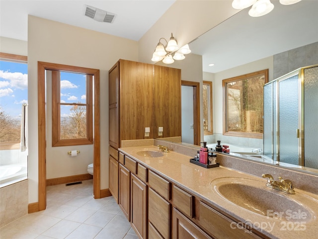 full bathroom featuring tile patterned floors, a chandelier, vanity, and a wealth of natural light