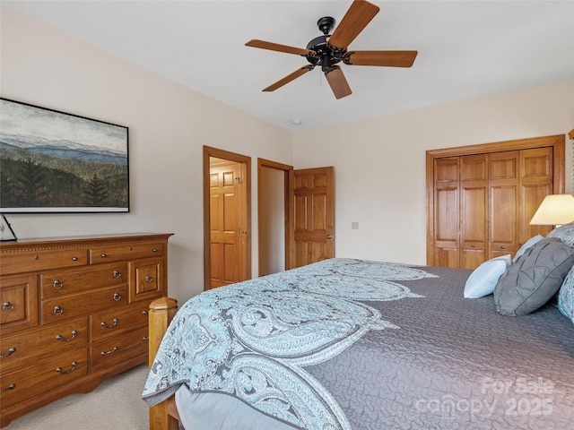 carpeted bedroom with a closet and ceiling fan