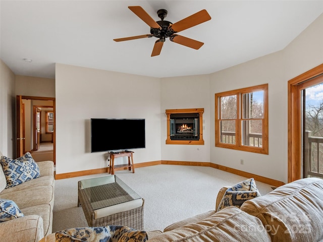 carpeted living room with ceiling fan