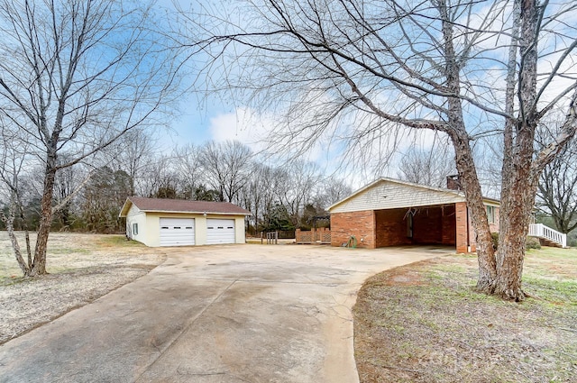 view of property exterior featuring a garage and an outbuilding