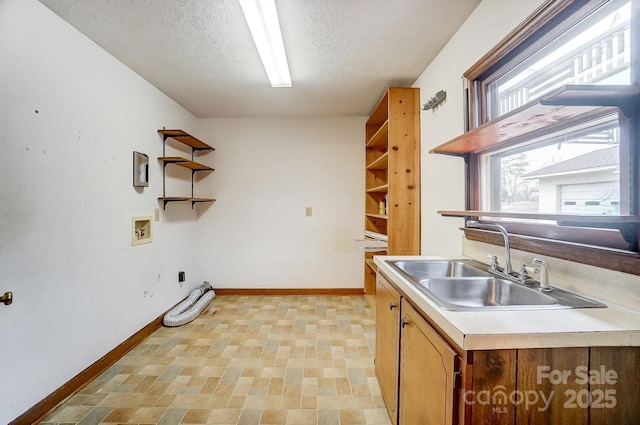 kitchen with sink and a textured ceiling