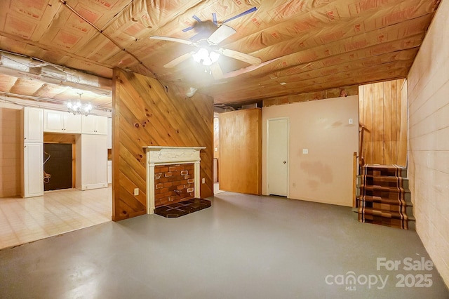 interior space with wood ceiling, ceiling fan, and wood walls