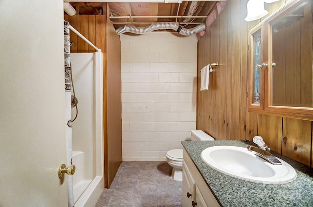 bathroom with walk in shower, vanity, and toilet