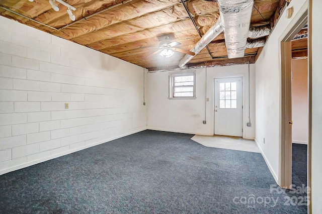 basement with wood ceiling and dark colored carpet