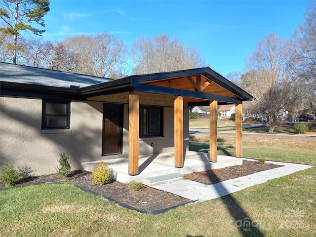 exterior space featuring a yard and covered porch