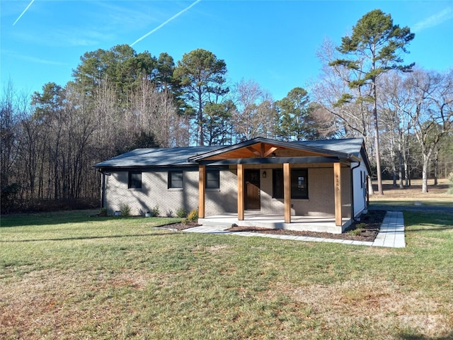 view of front of home with a patio and a front lawn