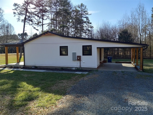 view of front of house with a front yard and a carport