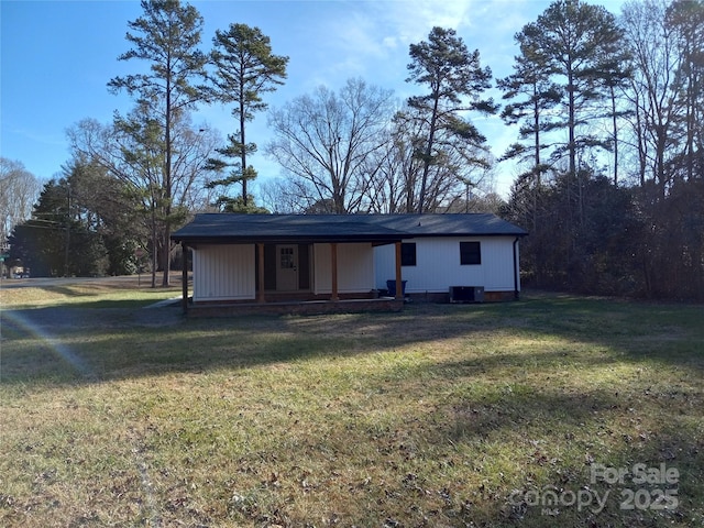 back of property with a lawn