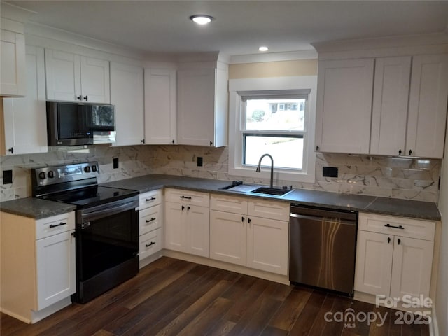 kitchen featuring sink, dark hardwood / wood-style flooring, stainless steel appliances, decorative backsplash, and white cabinets