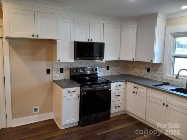 kitchen with dark hardwood / wood-style floors, sink, black range with electric cooktop, and white cabinets