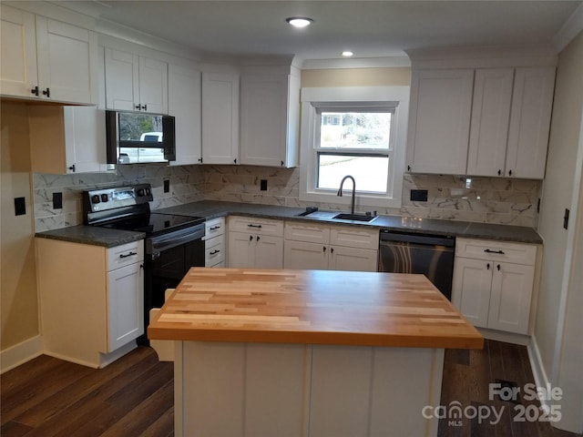 kitchen with wood counters, sink, black appliances, a kitchen island, and white cabinets