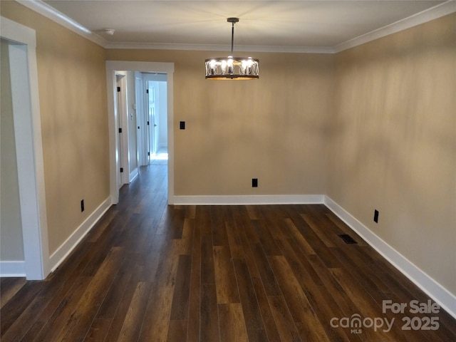 unfurnished dining area with a notable chandelier, ornamental molding, and dark hardwood / wood-style floors