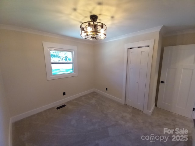 carpeted spare room with ornamental molding