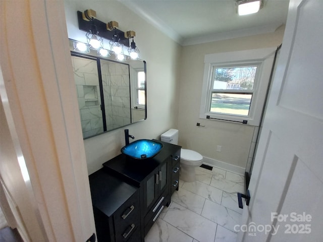 bathroom with vanity, crown molding, and toilet