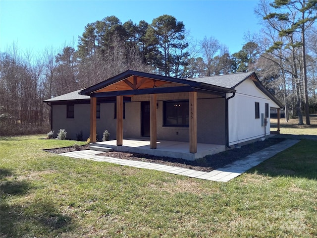 view of front of home with a front lawn and a patio