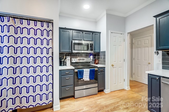 kitchen featuring light stone counters, ornamental molding, appliances with stainless steel finishes, light hardwood / wood-style floors, and decorative backsplash