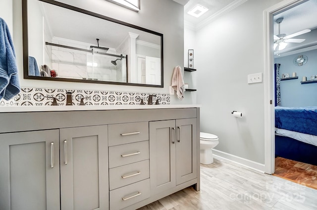 bathroom with hardwood / wood-style flooring, a shower with door, ornamental molding, and ceiling fan