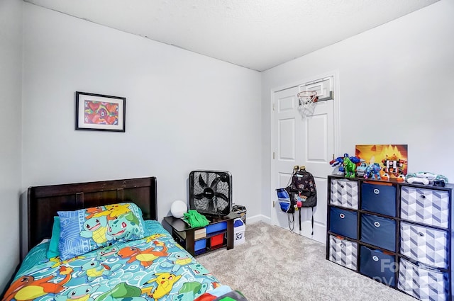 bedroom with light carpet and a textured ceiling