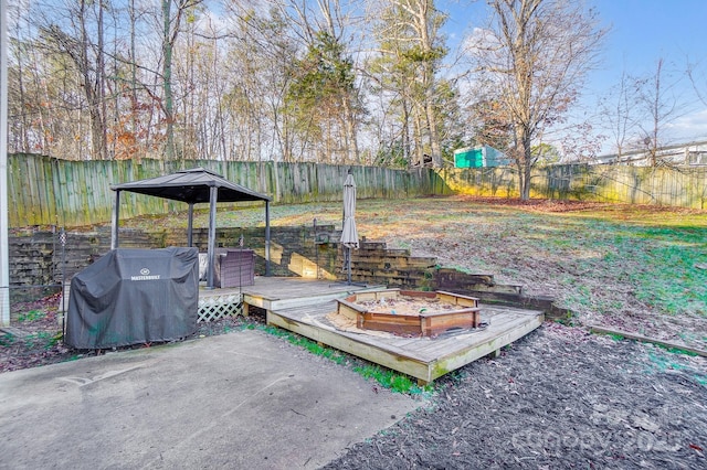 view of patio featuring a wooden deck and grilling area