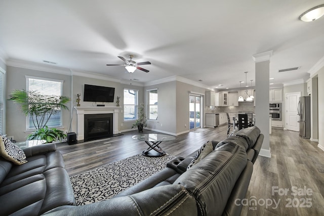 living room with ceiling fan, ornamental molding, and hardwood / wood-style floors