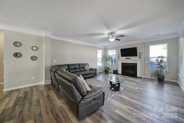 living room featuring hardwood / wood-style floors, a wealth of natural light, ceiling fan, and ornamental molding