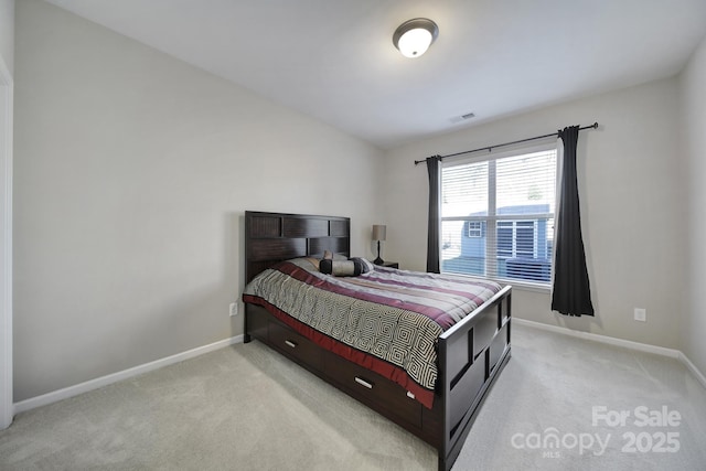 bedroom featuring light carpet and lofted ceiling