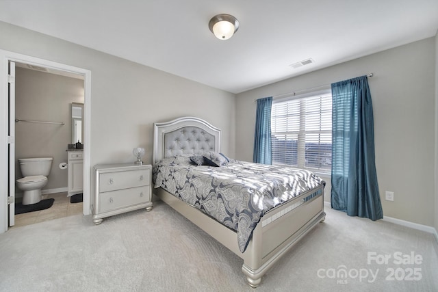 carpeted bedroom with ensuite bath