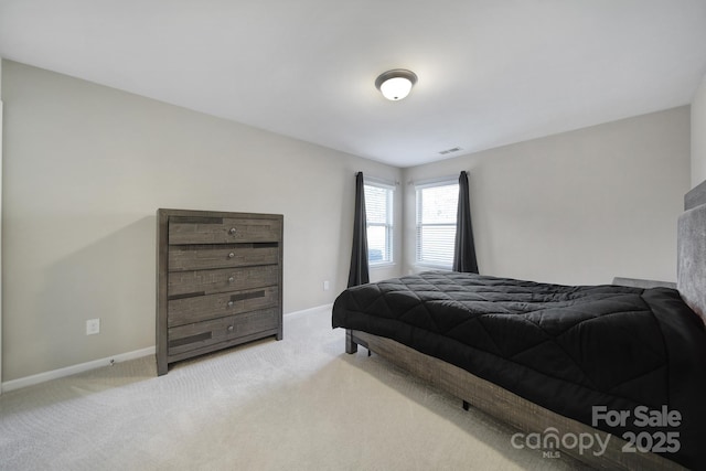 bedroom featuring light colored carpet