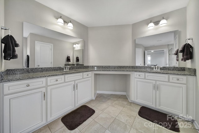 bathroom featuring tile patterned flooring and vanity