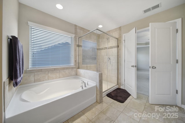 bathroom with tile patterned floors and independent shower and bath