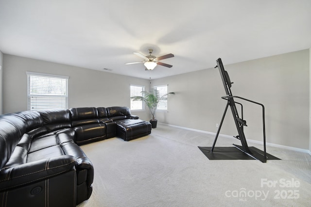 carpeted living room with ceiling fan