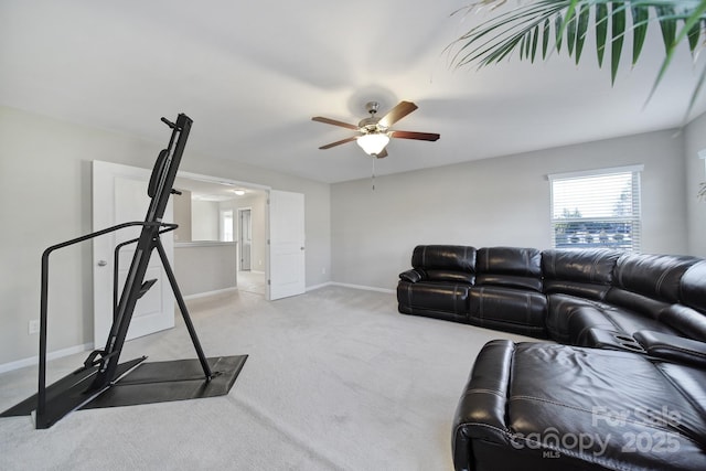 exercise room with ceiling fan and light carpet