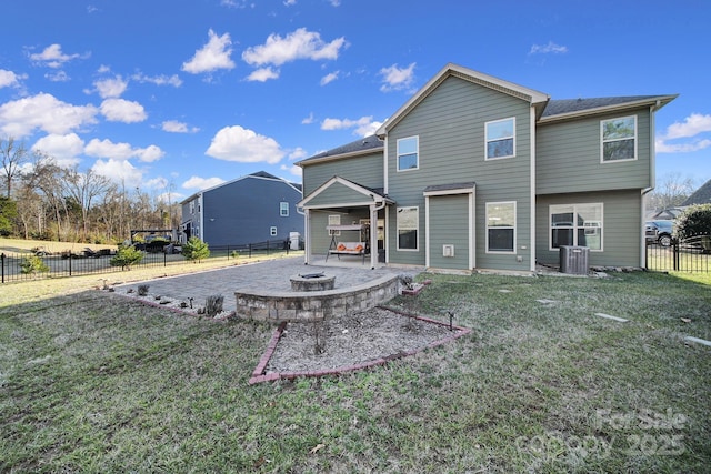 back of property with a patio area, a yard, central air condition unit, and an outdoor fire pit