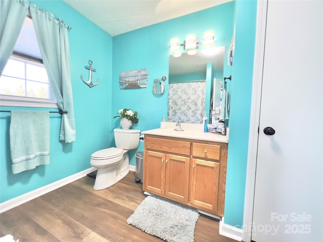 bathroom featuring hardwood / wood-style flooring, vanity, and toilet