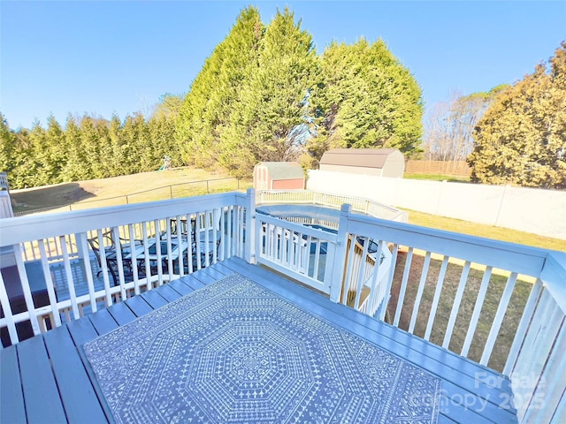 wooden deck featuring a storage unit