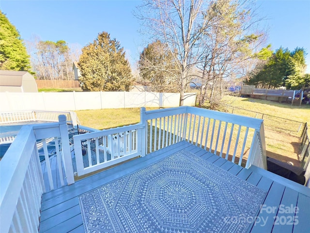 wooden terrace with a lawn