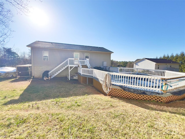 back of property with a wooden deck and a yard