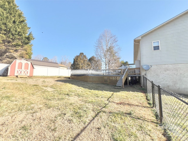 view of yard with a wooden deck and a storage shed