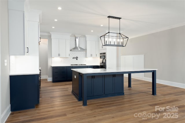 4243 Candlewood Dr Unit 9, Sherrills Ford, NC 28673 - kitchen featuring wall chimney exhaust hood, white cabinets, tasteful backsplash, crown molding, and light countertops