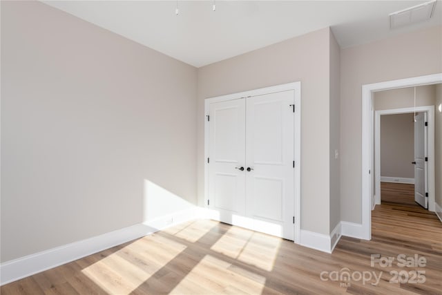 4243 Candlewood Dr Unit 9, Sherrills Ford, NC 28673 - unfurnished bedroom with baseboards, wood finished floors, visible vents, and a closet